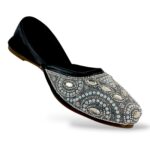 Elegant traditional ethnic footwear from our women's juttis wholesale collection featuring intricate pearl embroidery and crystal embellishments on a flat sole.