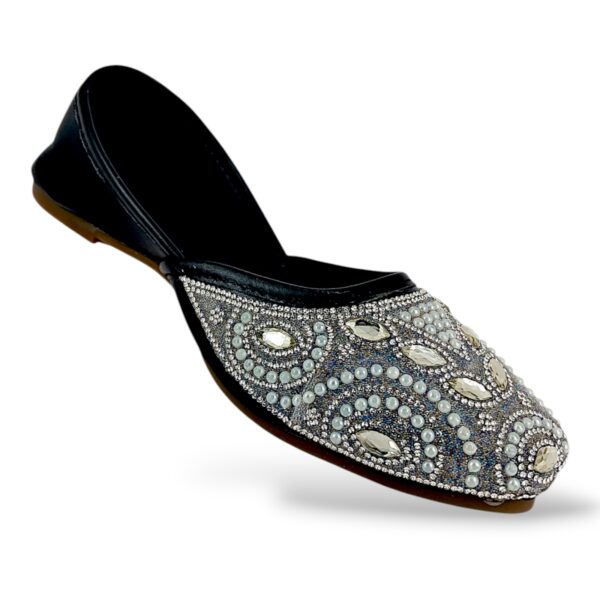 Elegant traditional ethnic footwear from our women's juttis wholesale collection featuring intricate pearl embroidery and crystal embellishments on a flat sole.