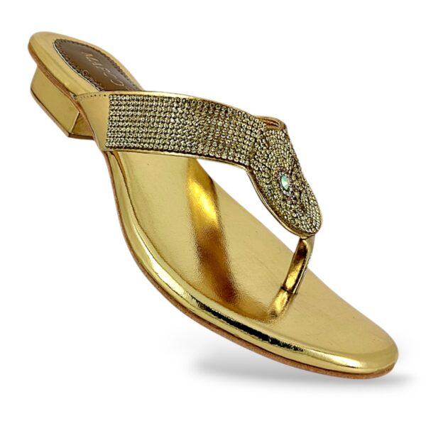 Women's low heel sandals wholesale featuring a metallic slip-on design with a rhinestone-embellished T-strap and a low block heel.